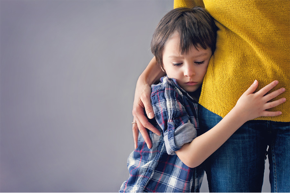 Boy hugging mother Margaret Lindgren and Kathleen Pastor Fund
